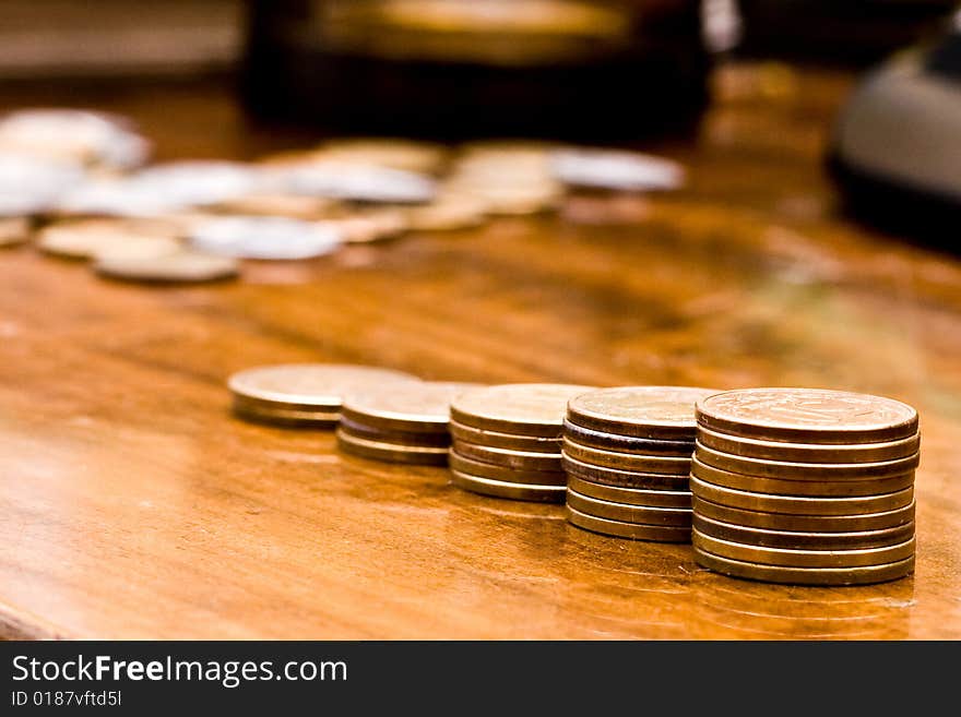 Stairway made of coins on brown tabke. Stairway made of coins on brown tabke