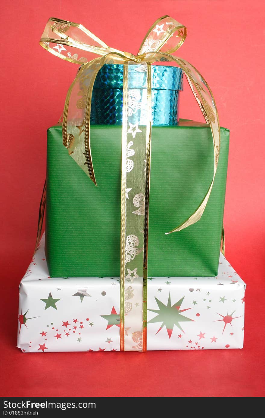 Christmas presents and golden ribbon in red background. Christmas presents and golden ribbon in red background