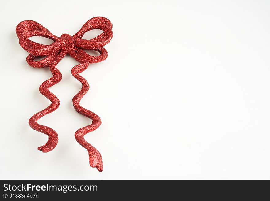 Decorative red shiny bow in white background. Decorative red shiny bow in white background