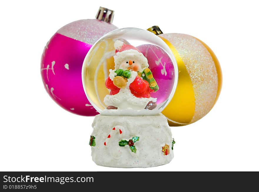 Snow globe - Christmas souvenir against two balls, isolated on white background