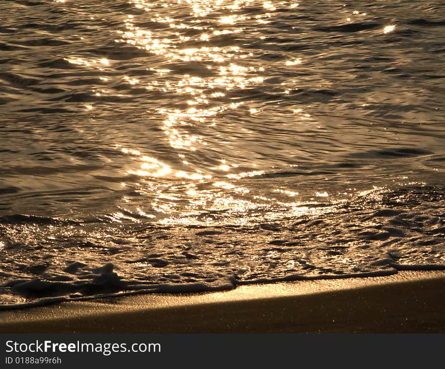 Photo of gold sea water on a beach. Photo of gold sea water on a beach