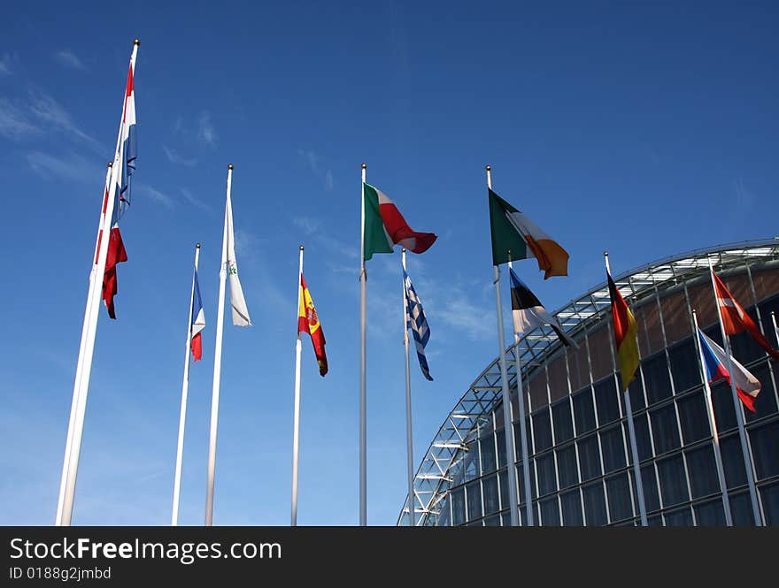 Modern glass building in Luxembourg with flags of Europe. Modern glass building in Luxembourg with flags of Europe