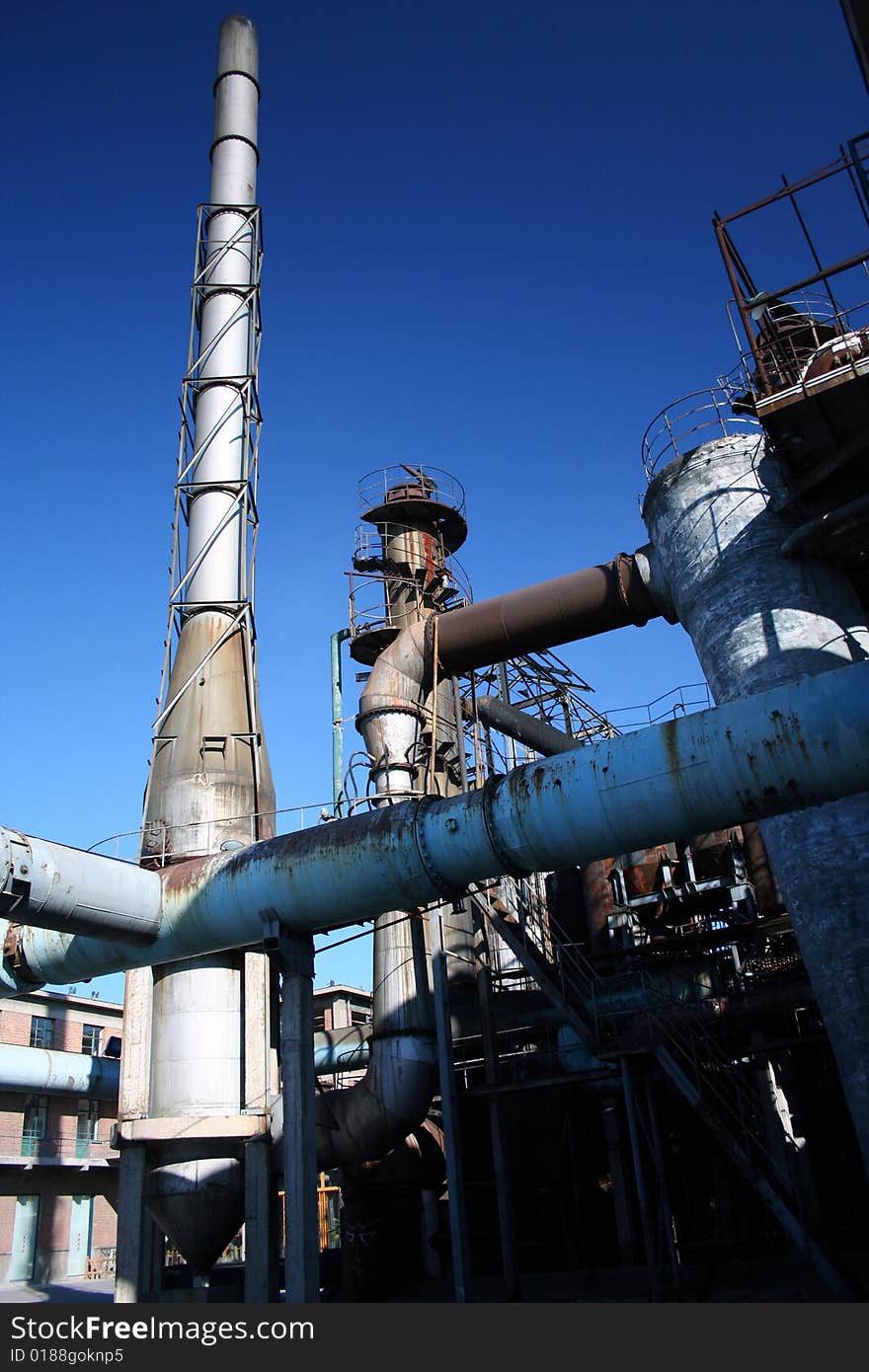 Tall chimneys and pipes of a coal factory in china for the production of heat and electricity