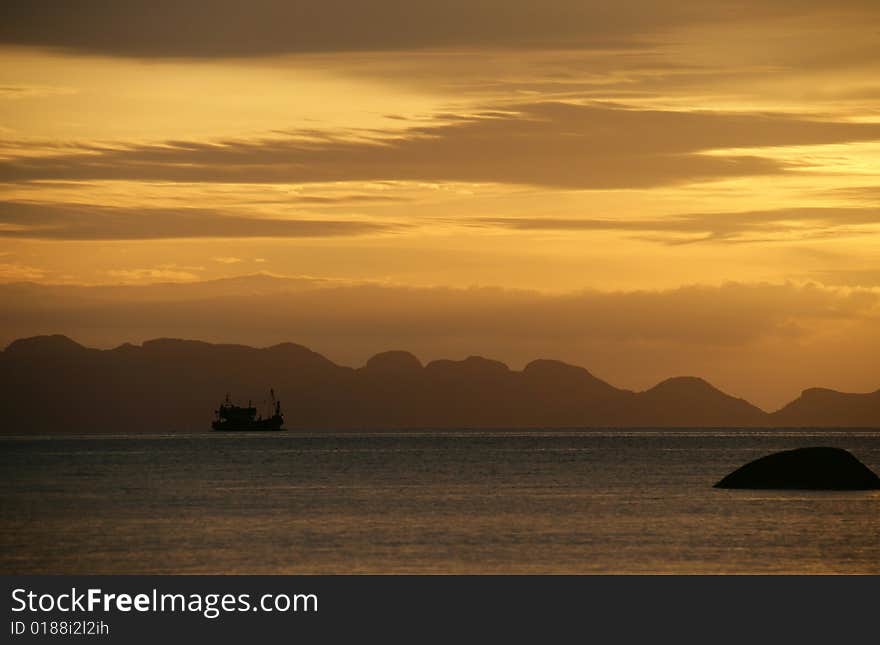 Original Thai fishing boat in the ocean on sunset. Original Thai fishing boat in the ocean on sunset