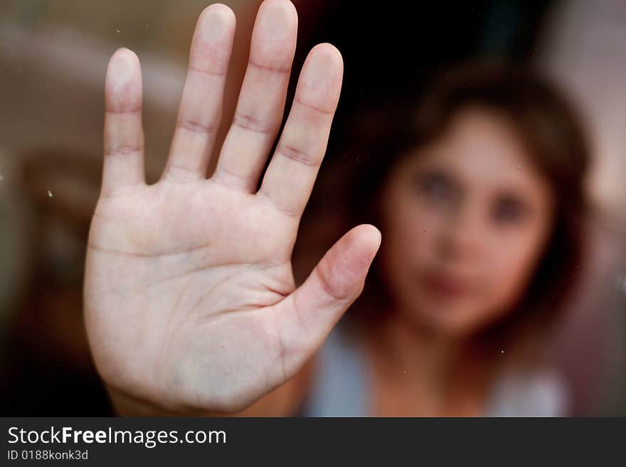 Lonely women In the glass. Hand close up.