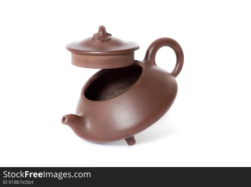 Brown ceramic chinese teapot. White background