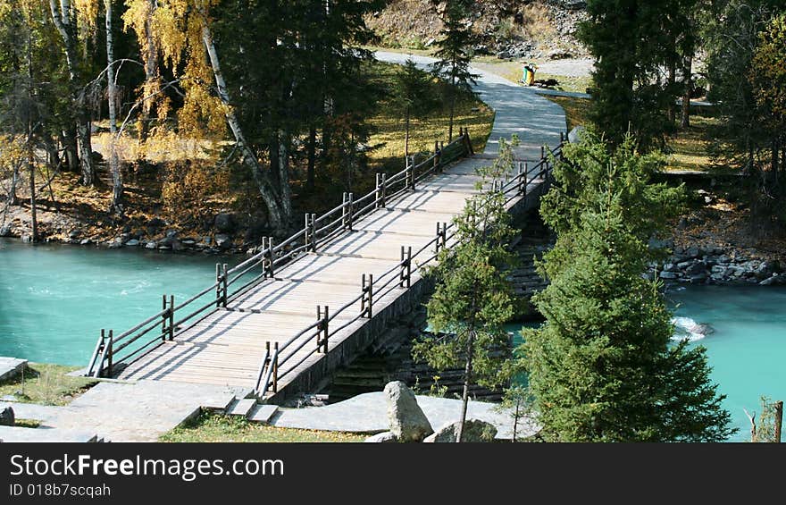 A wood bridge across Kanas river in the north of Xinjiang Province, China. A wood bridge across Kanas river in the north of Xinjiang Province, China.