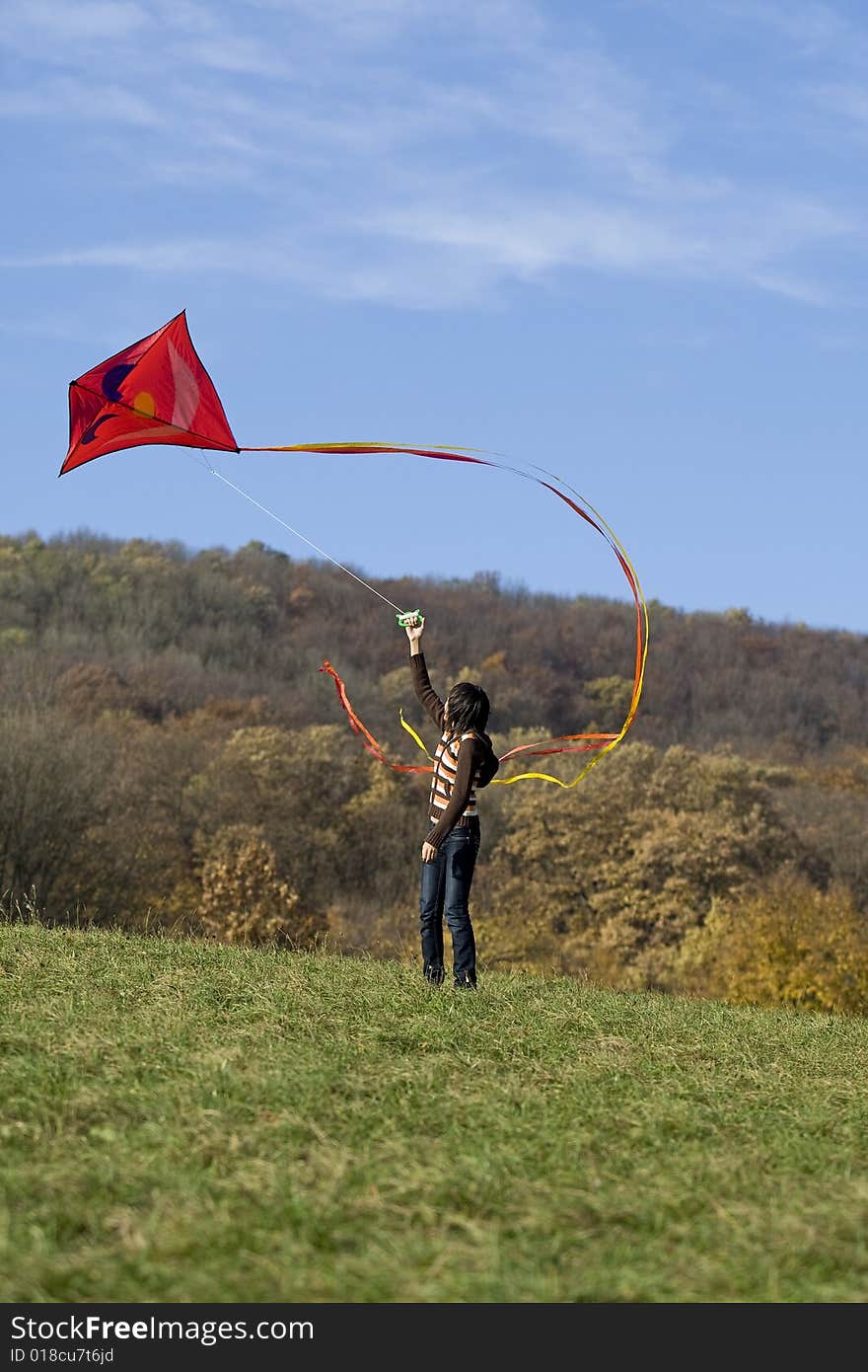 Fly a kite, teenager in fall weather in nature