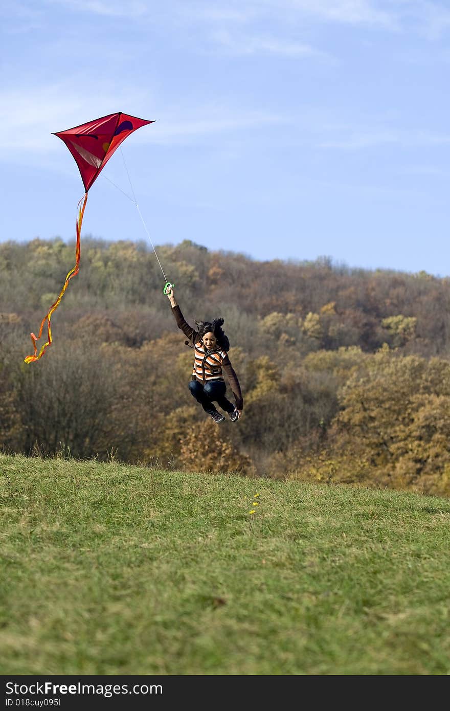 Fly a kite, teenager in fall weather in nature