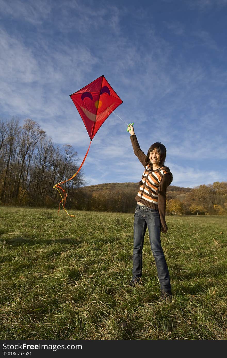 Fly a kite, teenager in fall weather in nature