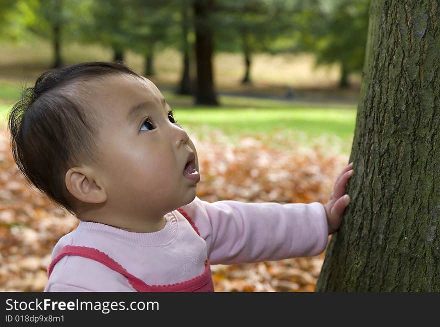 Smiling baby near tree