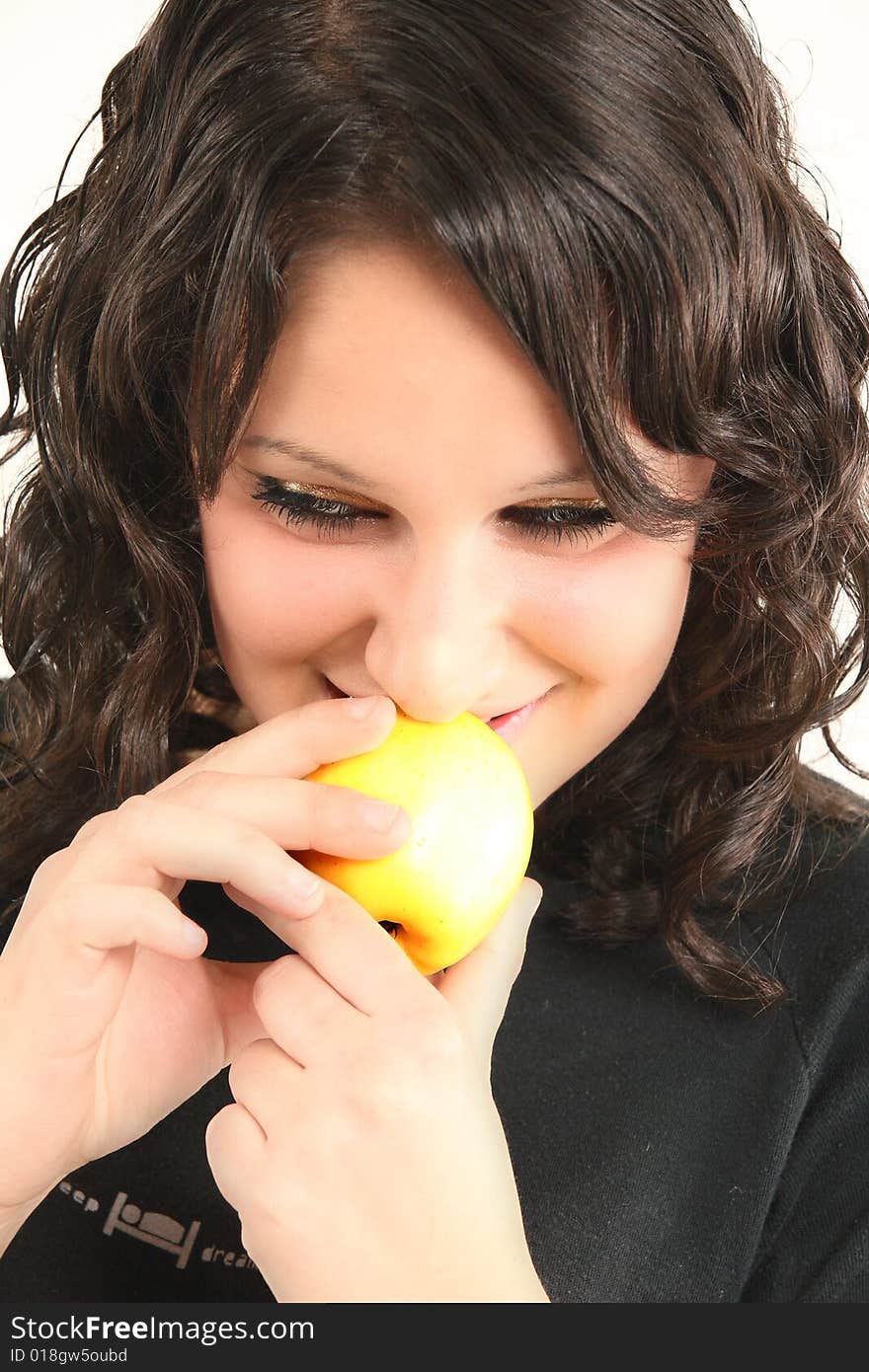 Teenage cute girl starts eat an apple. Teenage cute girl starts eat an apple