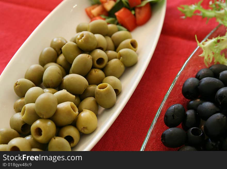 Mixed olives for aperitifs on red table. Mixed olives for aperitifs on red table