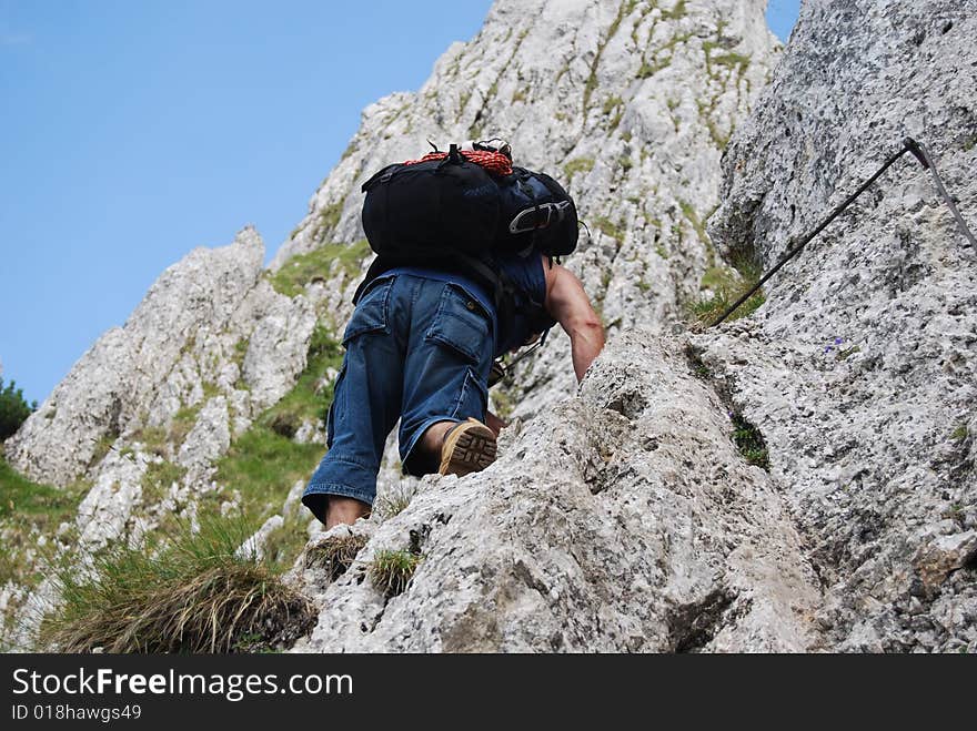 Mountaineer reaching for the top of the mountain