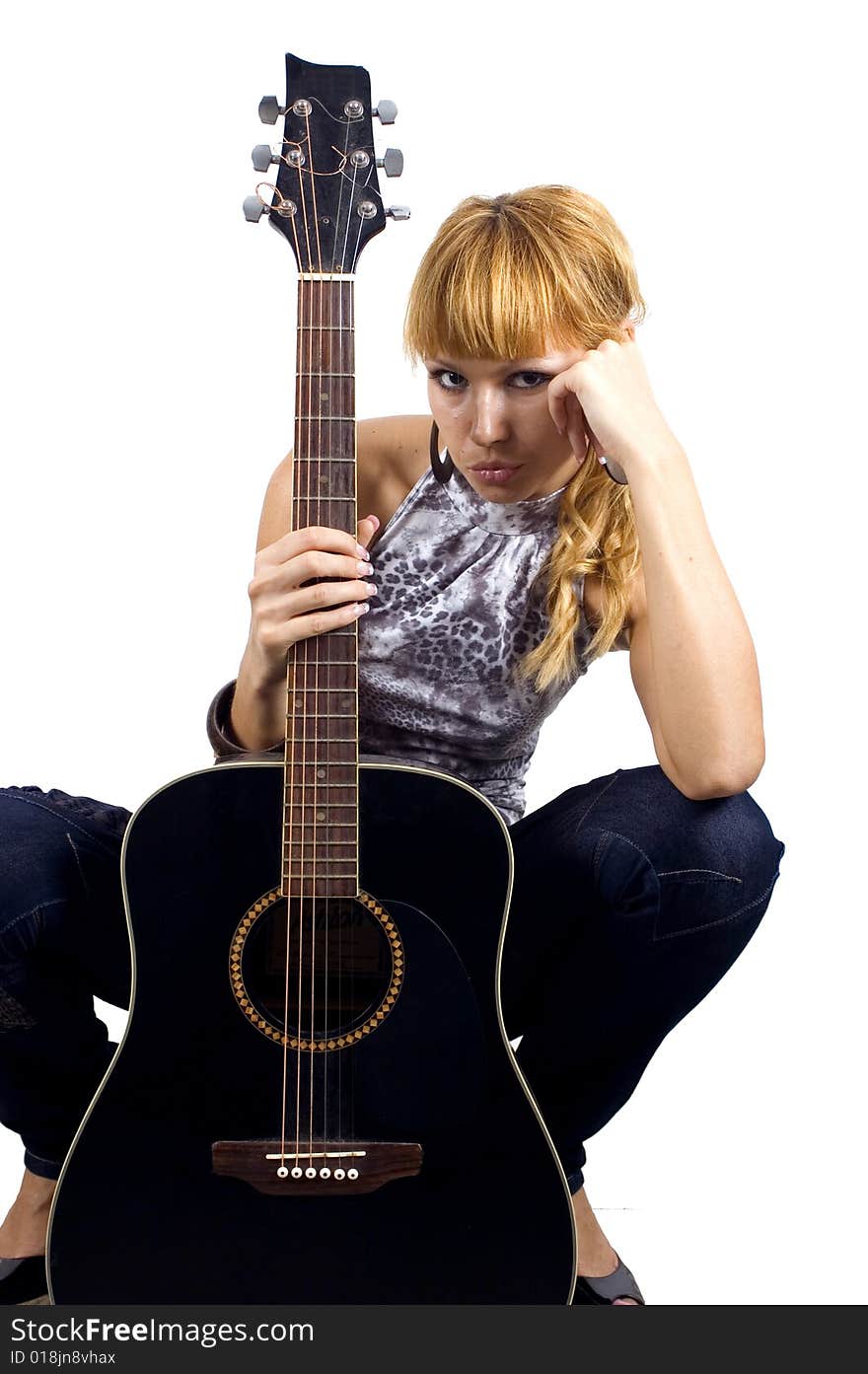 Pretty, blonde girl holding guitar, sad face expression, close portrait. Pretty, blonde girl holding guitar, sad face expression, close portrait.