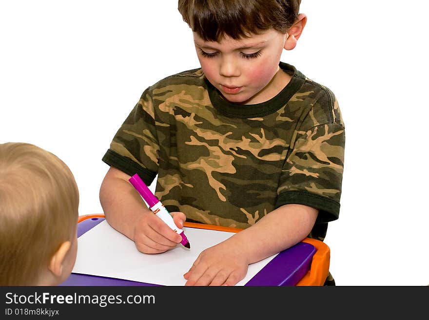 One brother showing the other how to draw on a white background. One brother showing the other how to draw on a white background