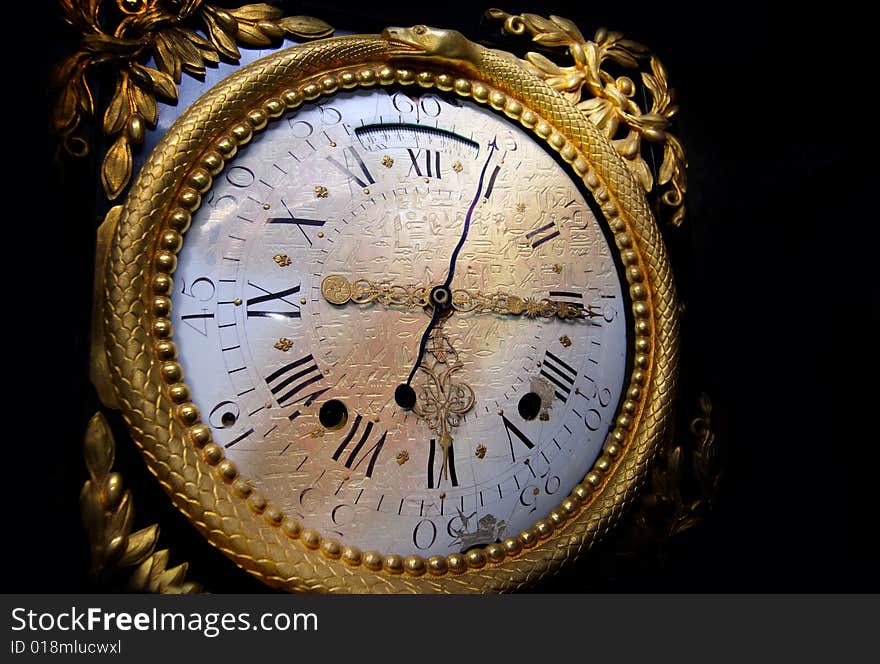 Ancient french clock dial, against dark background, with an egypt text gradually arising in the middle. 
The light is slanting; distortion filter (zig-zag) was slightly applied to imitate kind of liquide surface.
. Ancient french clock dial, against dark background, with an egypt text gradually arising in the middle. 
The light is slanting; distortion filter (zig-zag) was slightly applied to imitate kind of liquide surface.