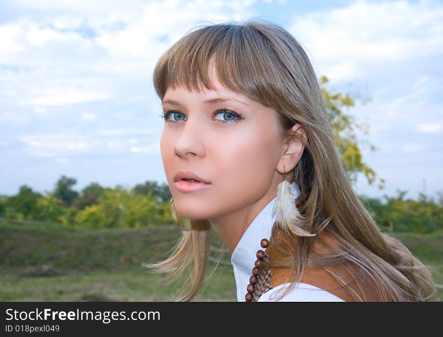 Portrait of the beautiful young girl against green foliage. Portrait of the beautiful young girl against green foliage