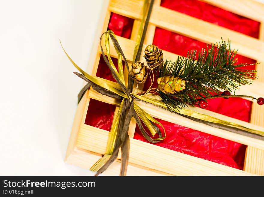 Xmas wooden gift box with pine decoration on white background