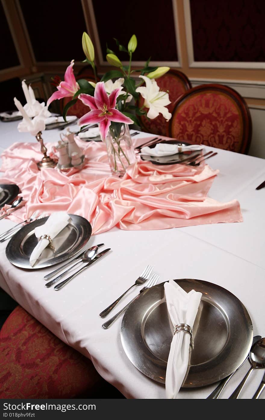 Old style dinning room table set for a formal dinner. Old style dinning room table set for a formal dinner.