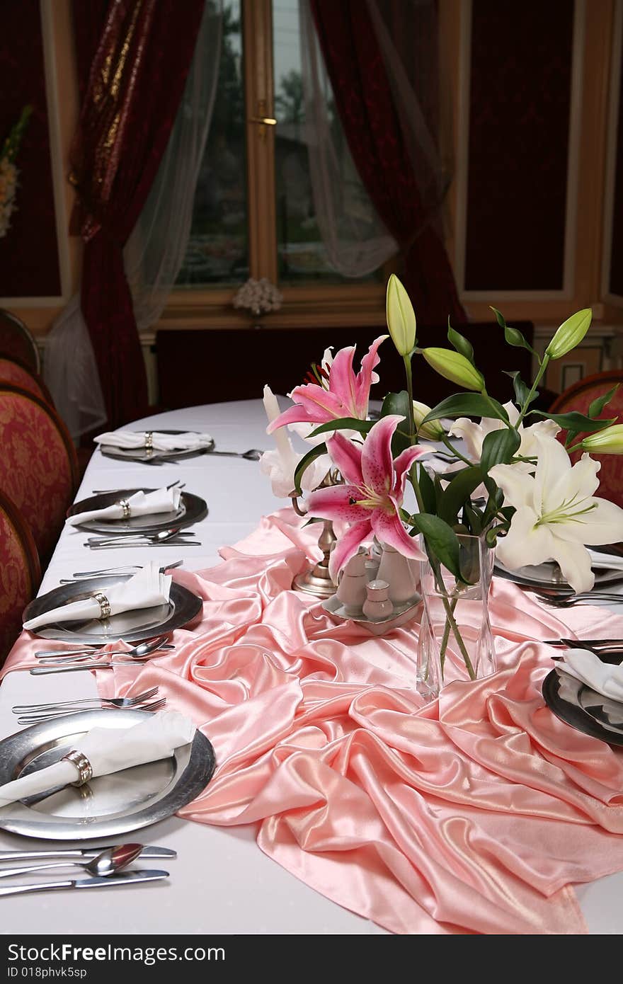 Old style dinning room table set for a formal dinner. Old style dinning room table set for a formal dinner.