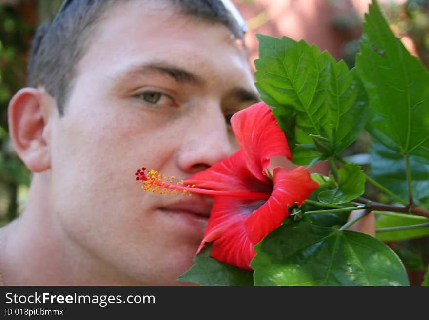 The guy smells a flower