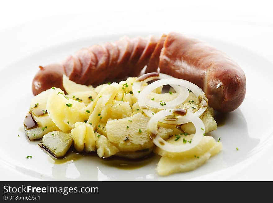 Kransky sausage with boiled potato, onion and pump