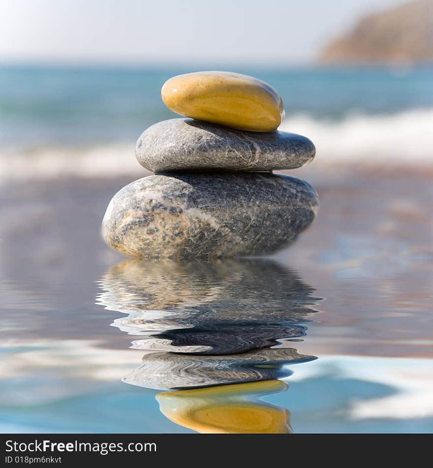 Stack of pebbles on sea background