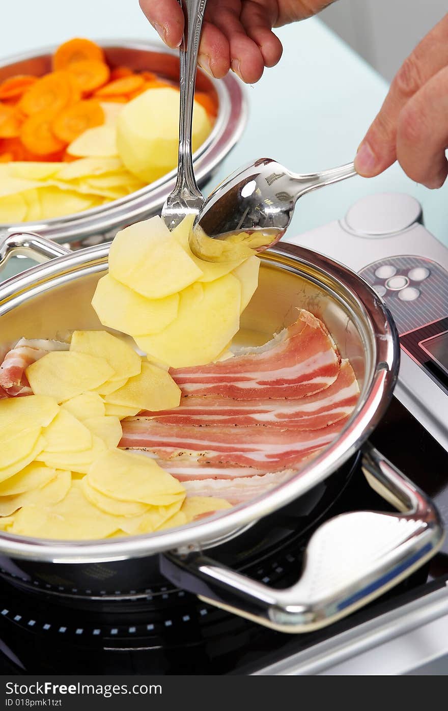 Preparing of meat moussaka in metal vessel