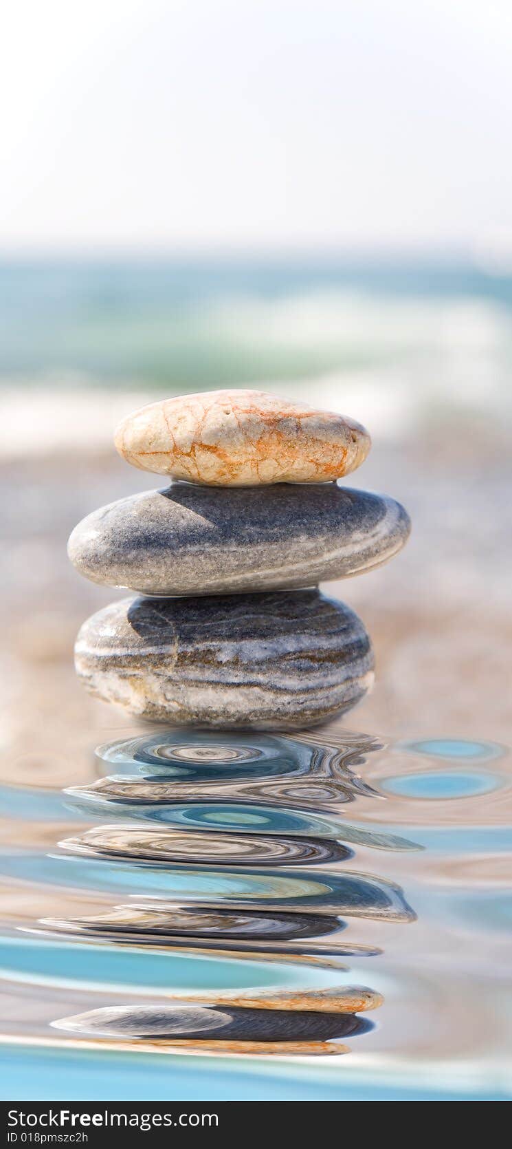 Stack of pebbles on sea background