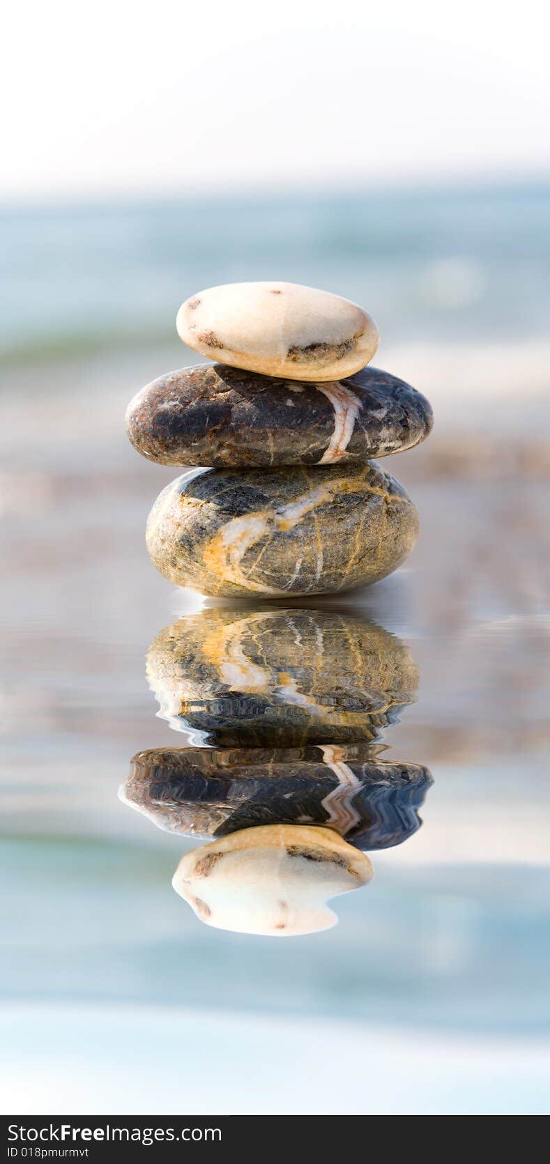 Stack of pebbles on sea background