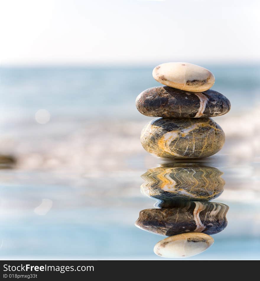 Stack of pebbles on sea background