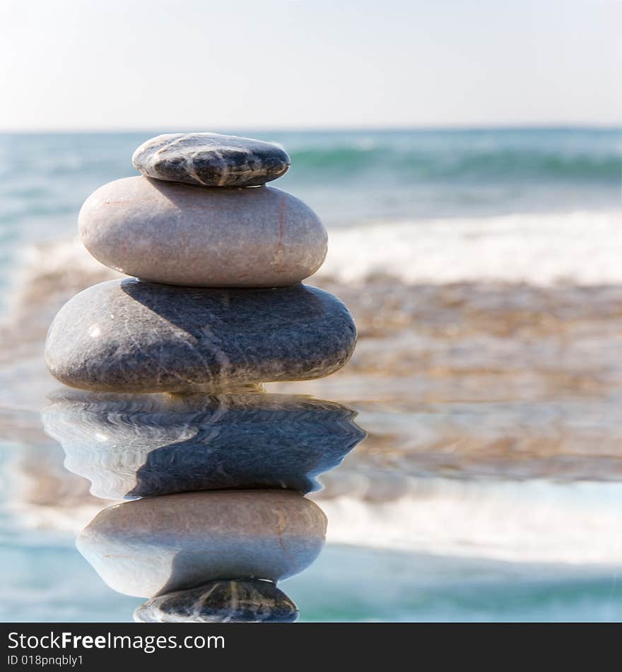 Stack of pebbles on sea background