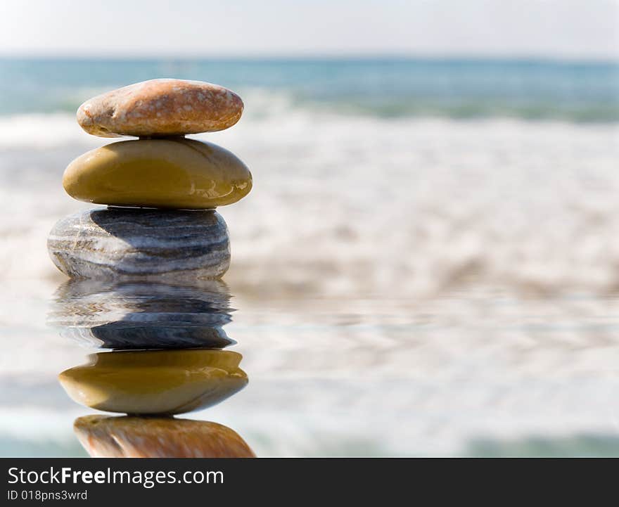 Stack of pebbles on sea background