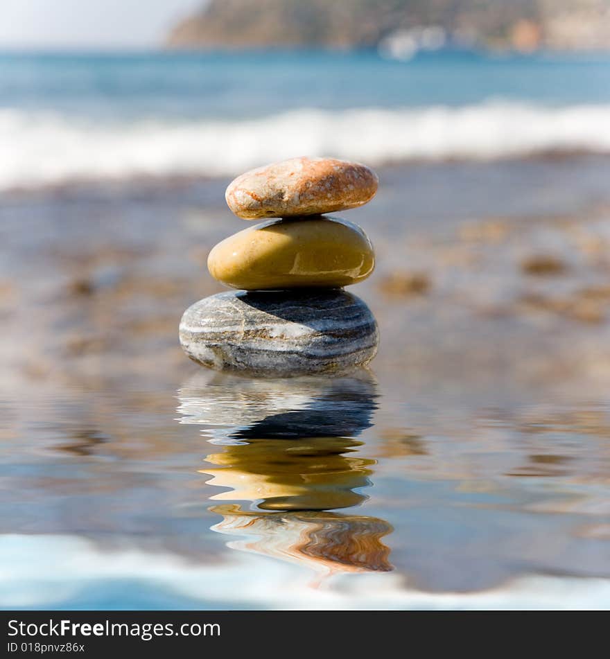 Stack of pebbles on sea background