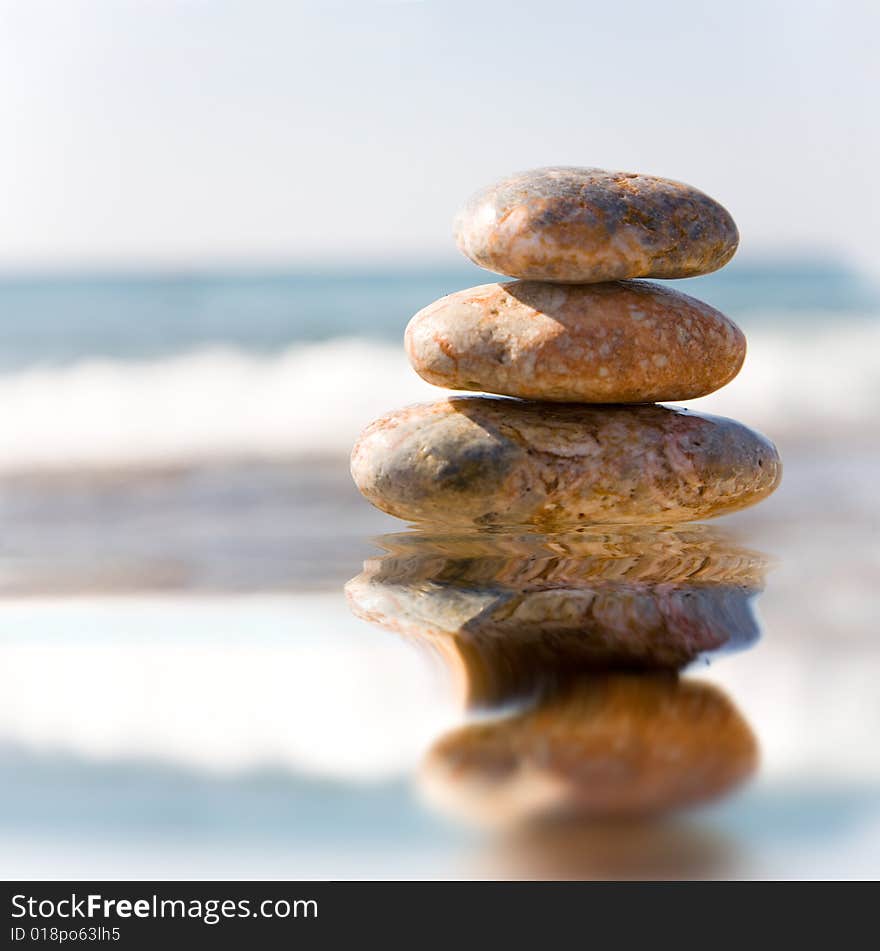 Stack of pebbles on sea background