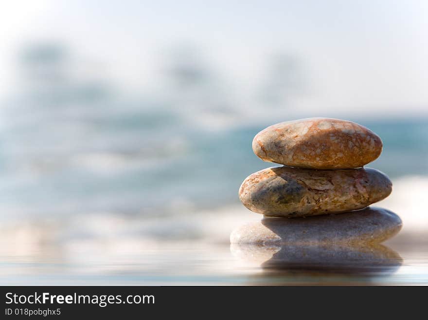 Stack of pebbles on sea background