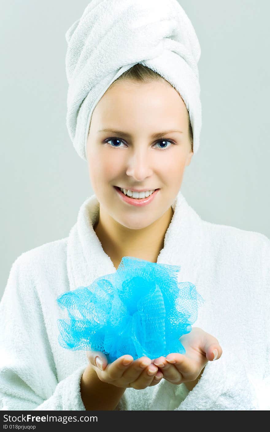 Beautiful girl with blue bath sponge.