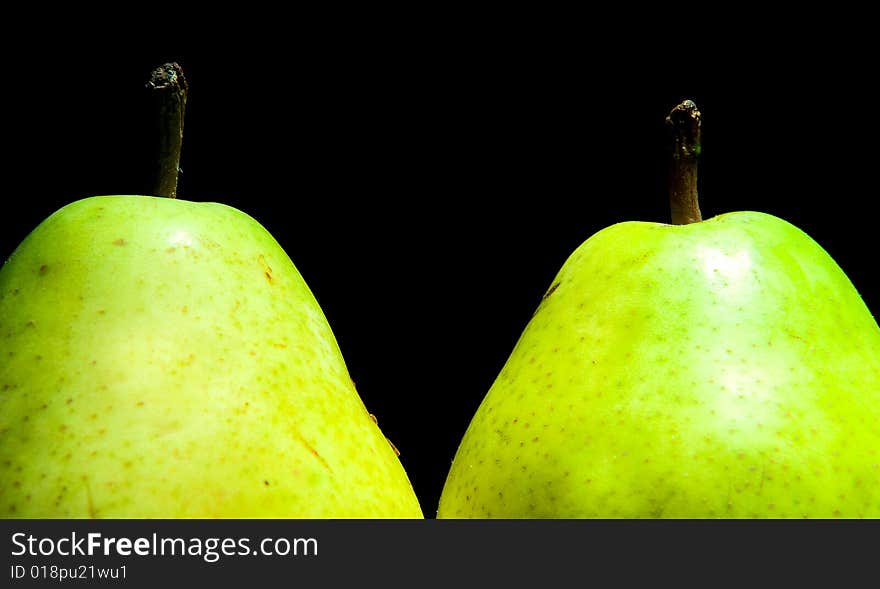 Pair of pears isolated on black background. Pair of pears isolated on black background