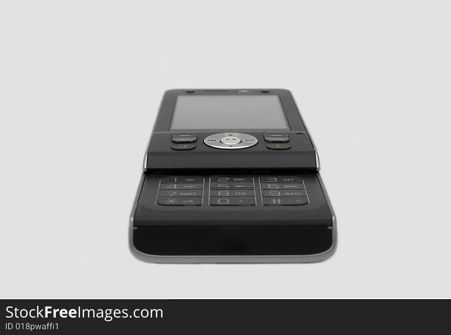 Small black mobile phone isolated on background