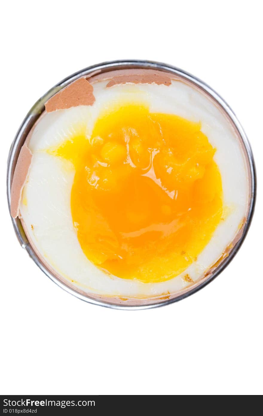 Brown egg in an eggcup on white background