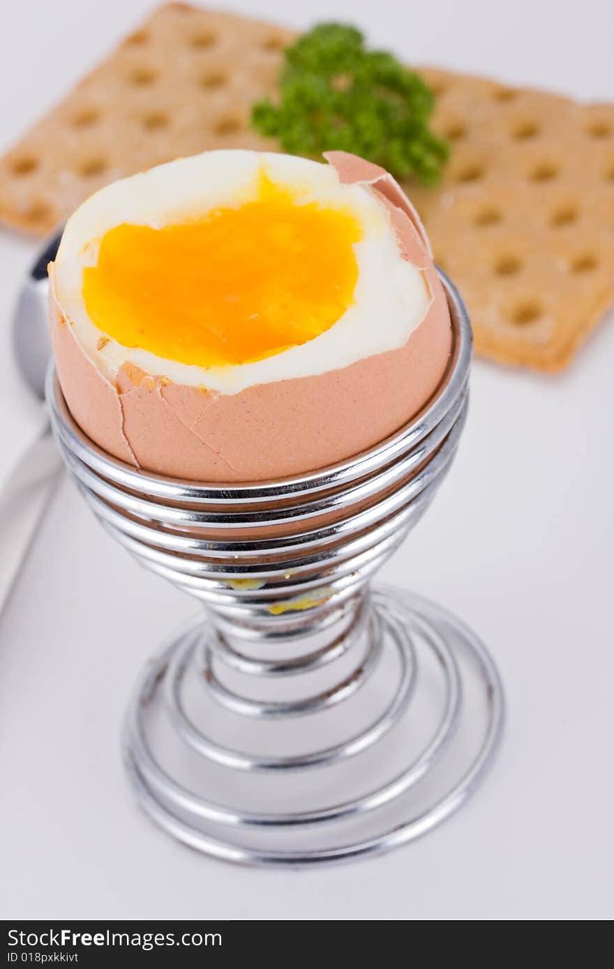 Brown egg in an eggcup and crispbread. Brown egg in an eggcup and crispbread