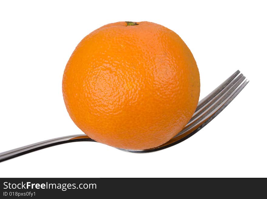 Tangerine on a fork over white background