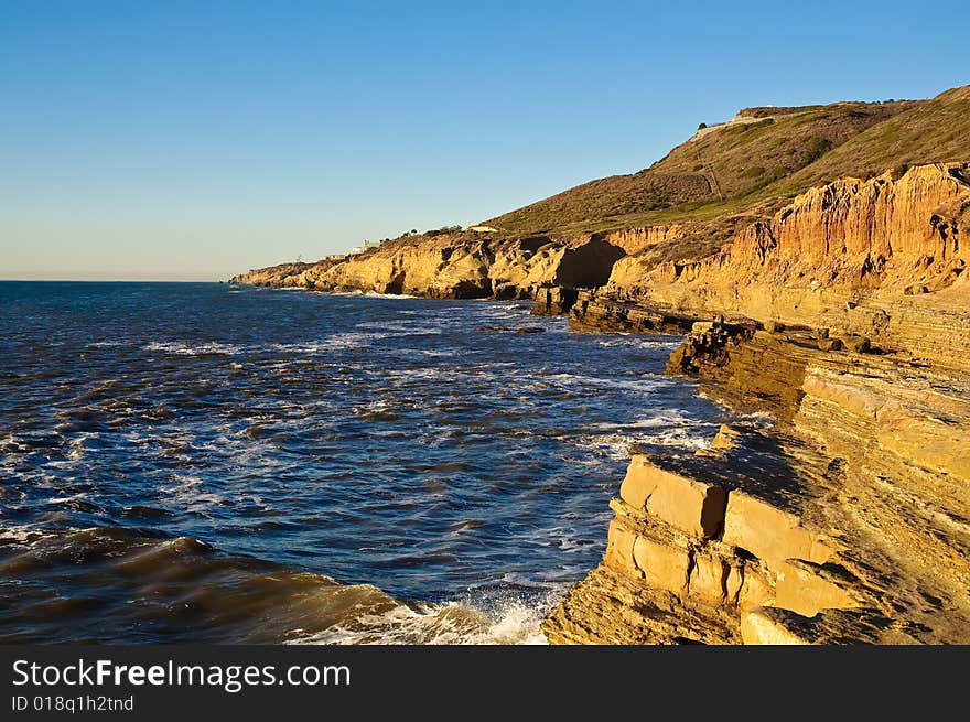 Cliffs next to the Pacific Ocean with tidepools on a clear day. Cliffs next to the Pacific Ocean with tidepools on a clear day.