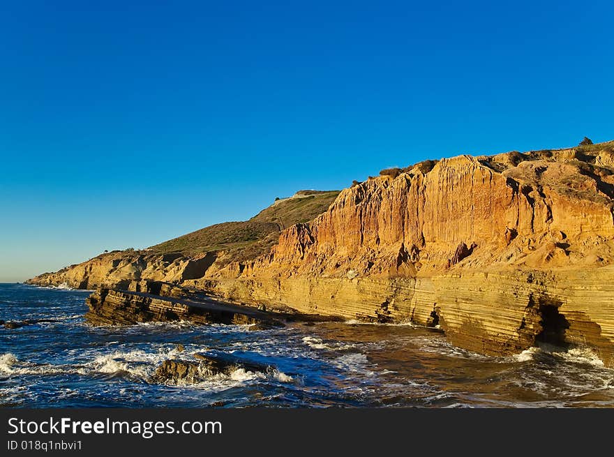 Cliffs next to the Pacific Ocean with tidepools on a clear day. Cliffs next to the Pacific Ocean with tidepools on a clear day.