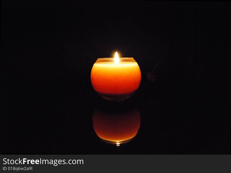 A candle with black background