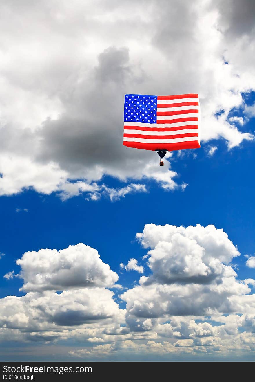 An American flag hot-air balloon under a sunny sky