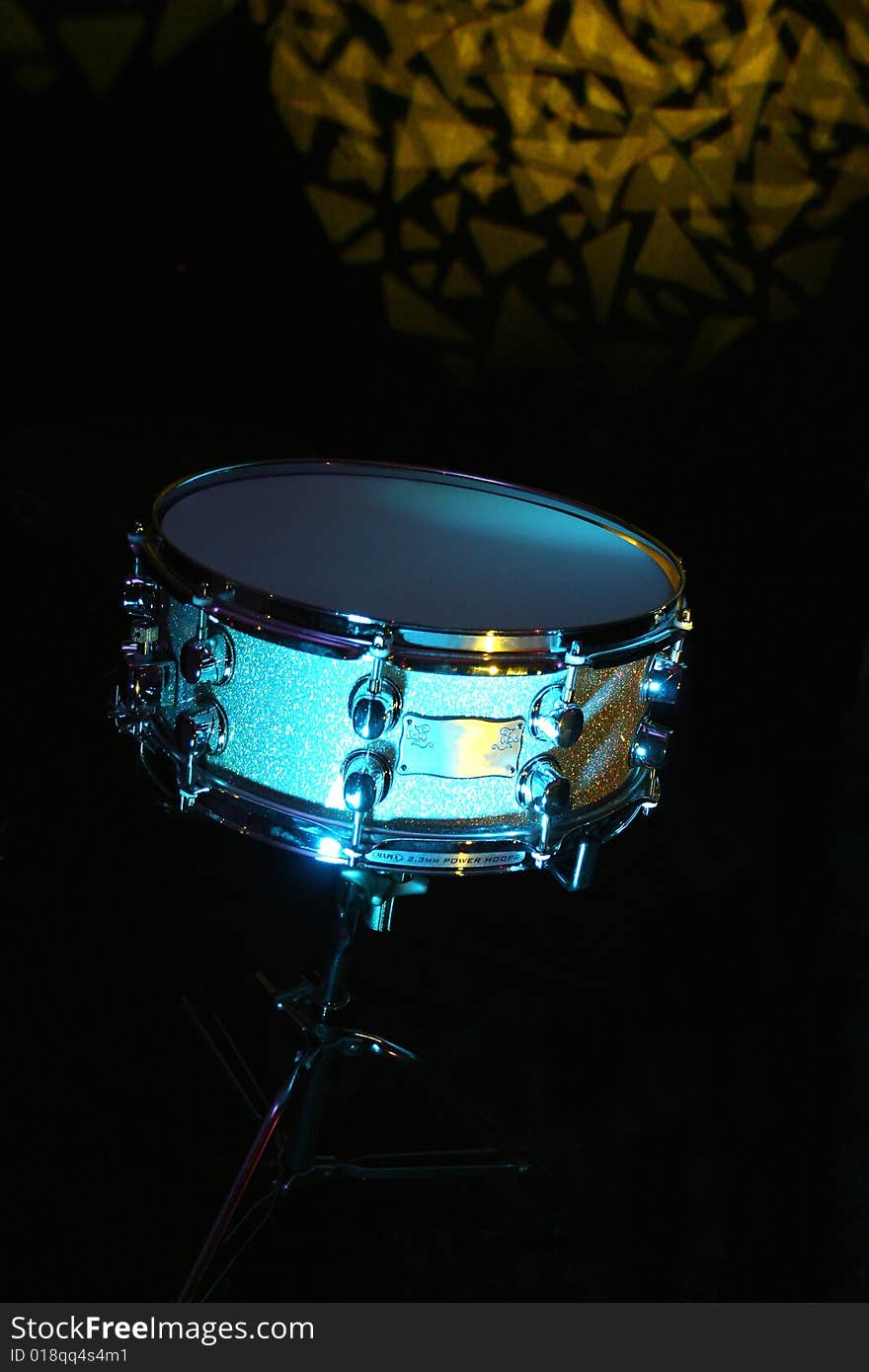 The snare drum is a drum with strands of snares made of curled metal wire, metal cable, plastic cable, or gut cords stretched across the a drumhead, typically the bottom. The snare drum is typically used to play a backbeat pattern such as quarter notes on the backbeat or the slightly more interesting: also sometimes in slow band songs they use a brush to touch the snare instead of hitting it with a wooden drum stick.