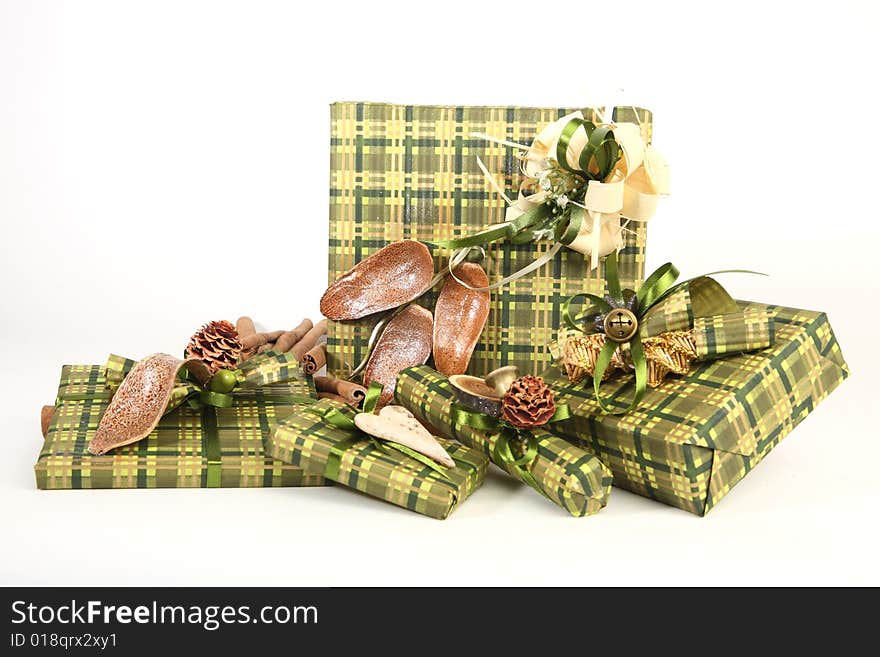 Five christmas presents in green paper with unusual decorations