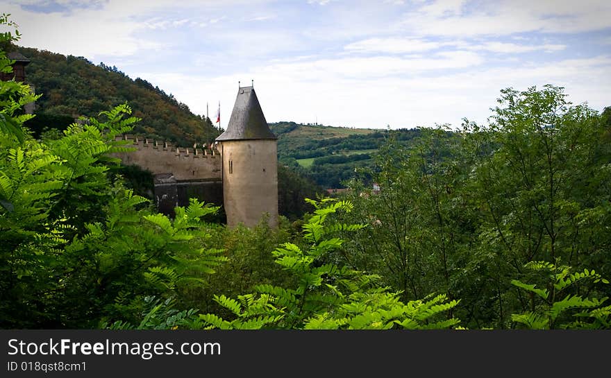 View on the castle walls and turret though the leaves. View on the castle walls and turret though the leaves